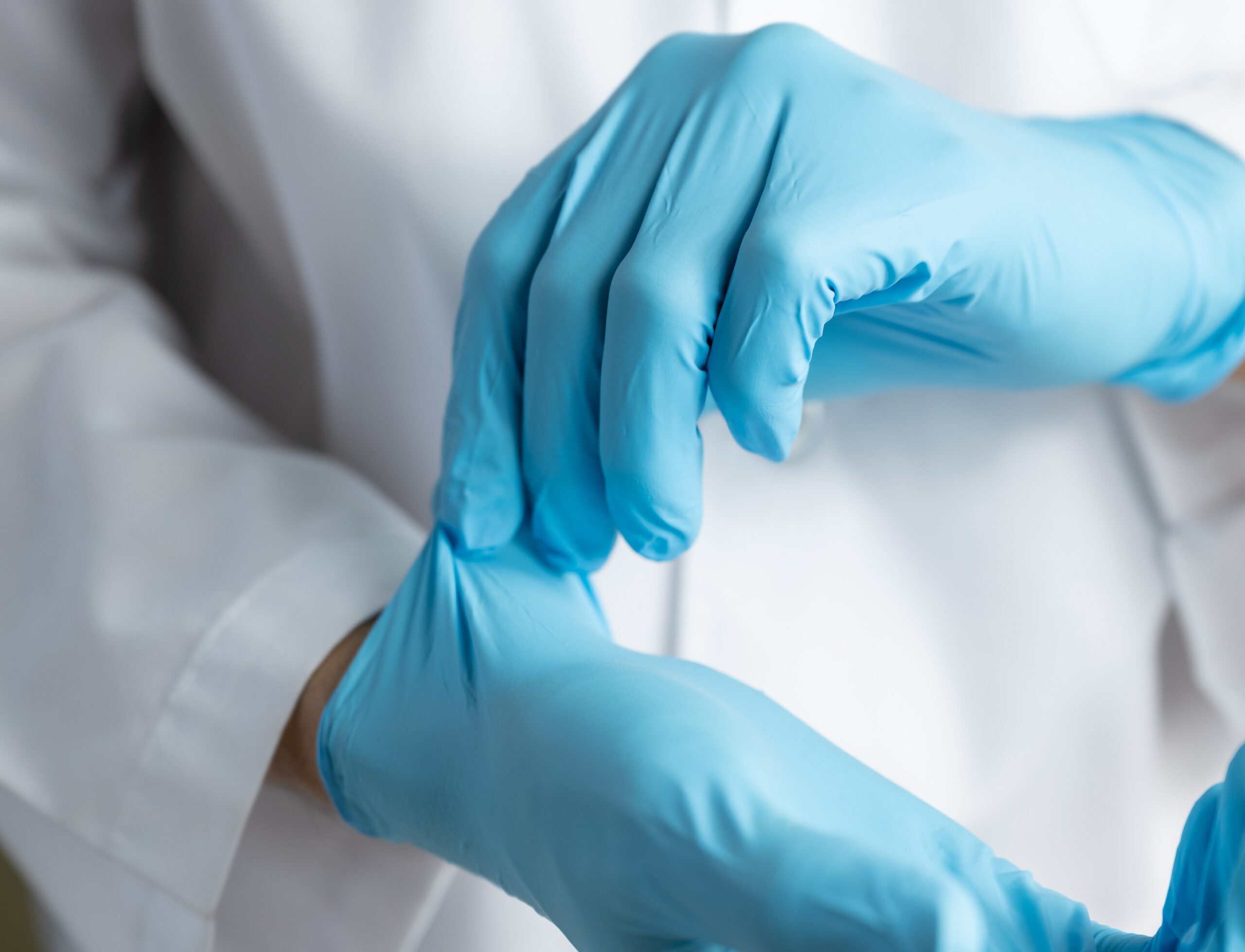 Doctor wearing blue nitrile gloves