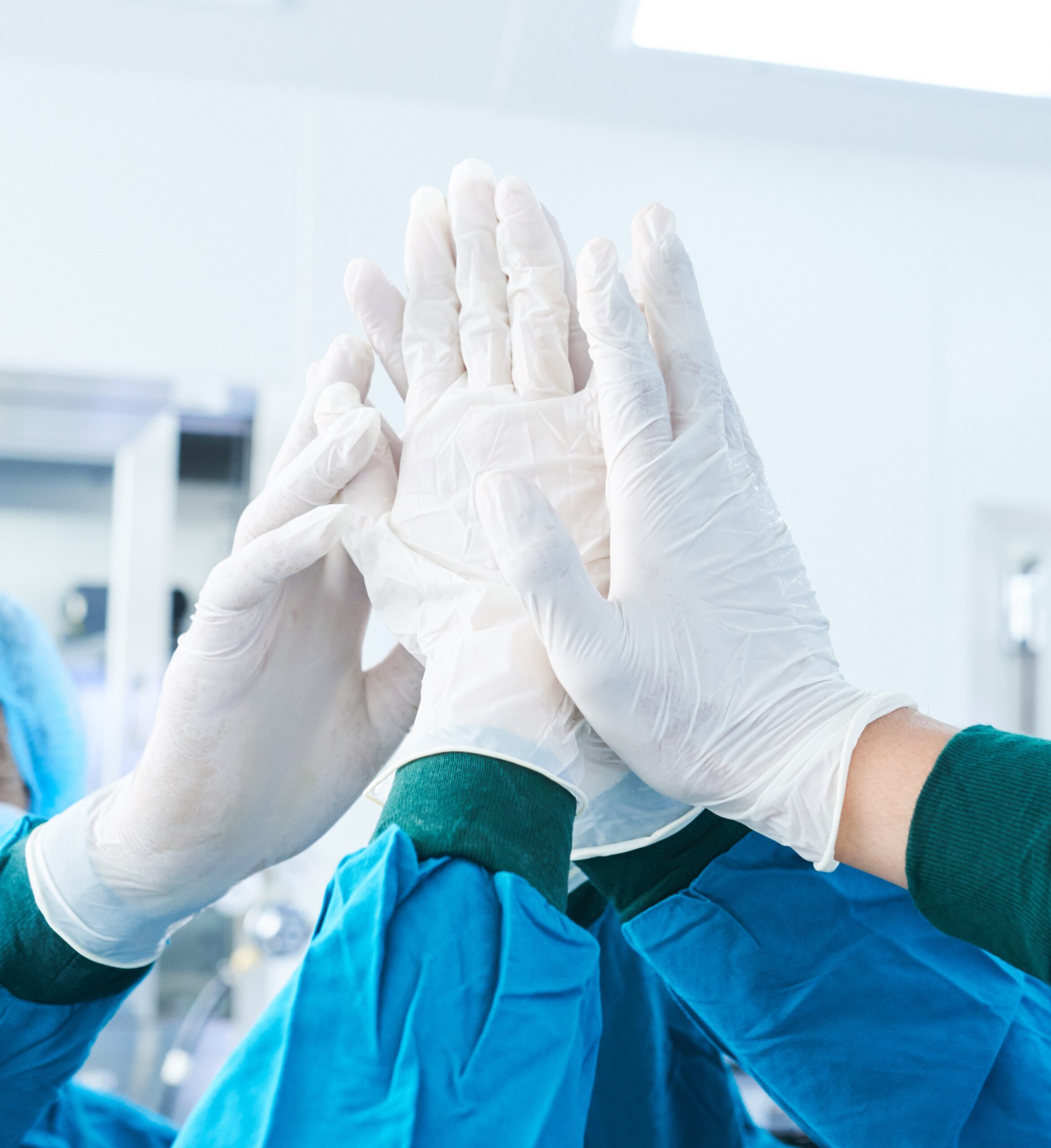 Surgical team high-fiving before surgery