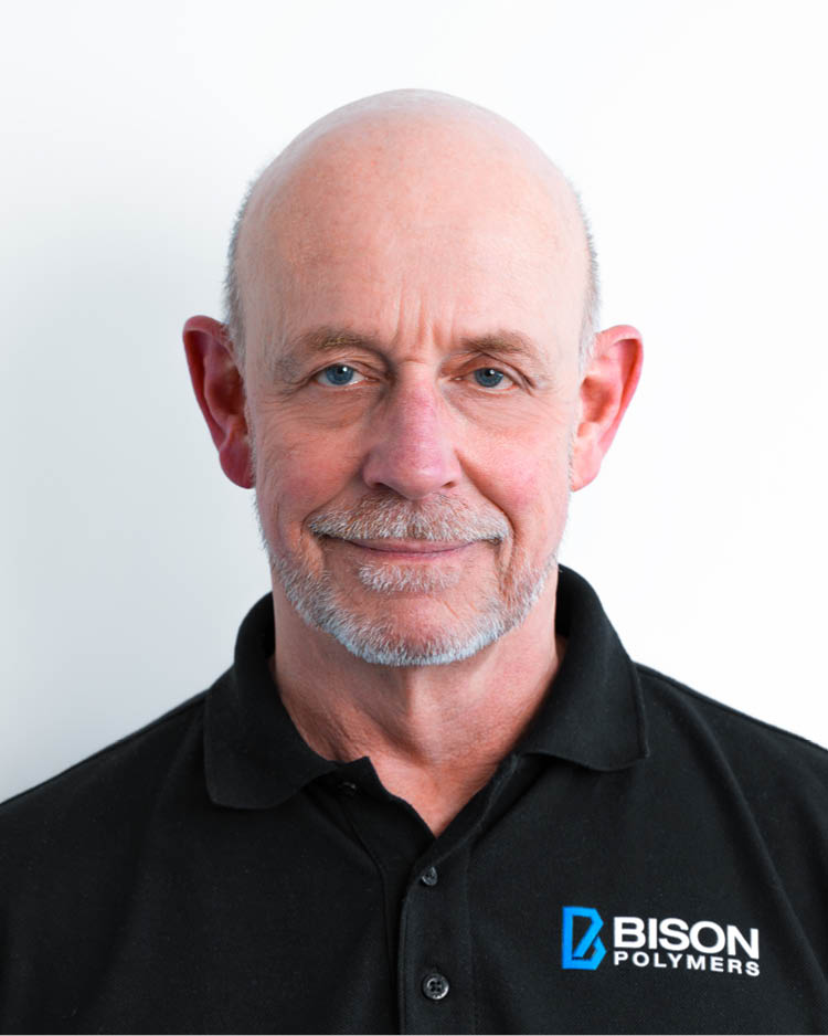 Bernd Burgmer wearing a black polo shirt with the BISON Polymers logo