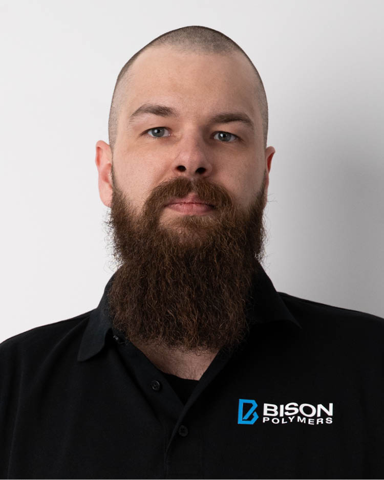 Tim Heide wearing a black polo shirt with the BISON Polymers logo